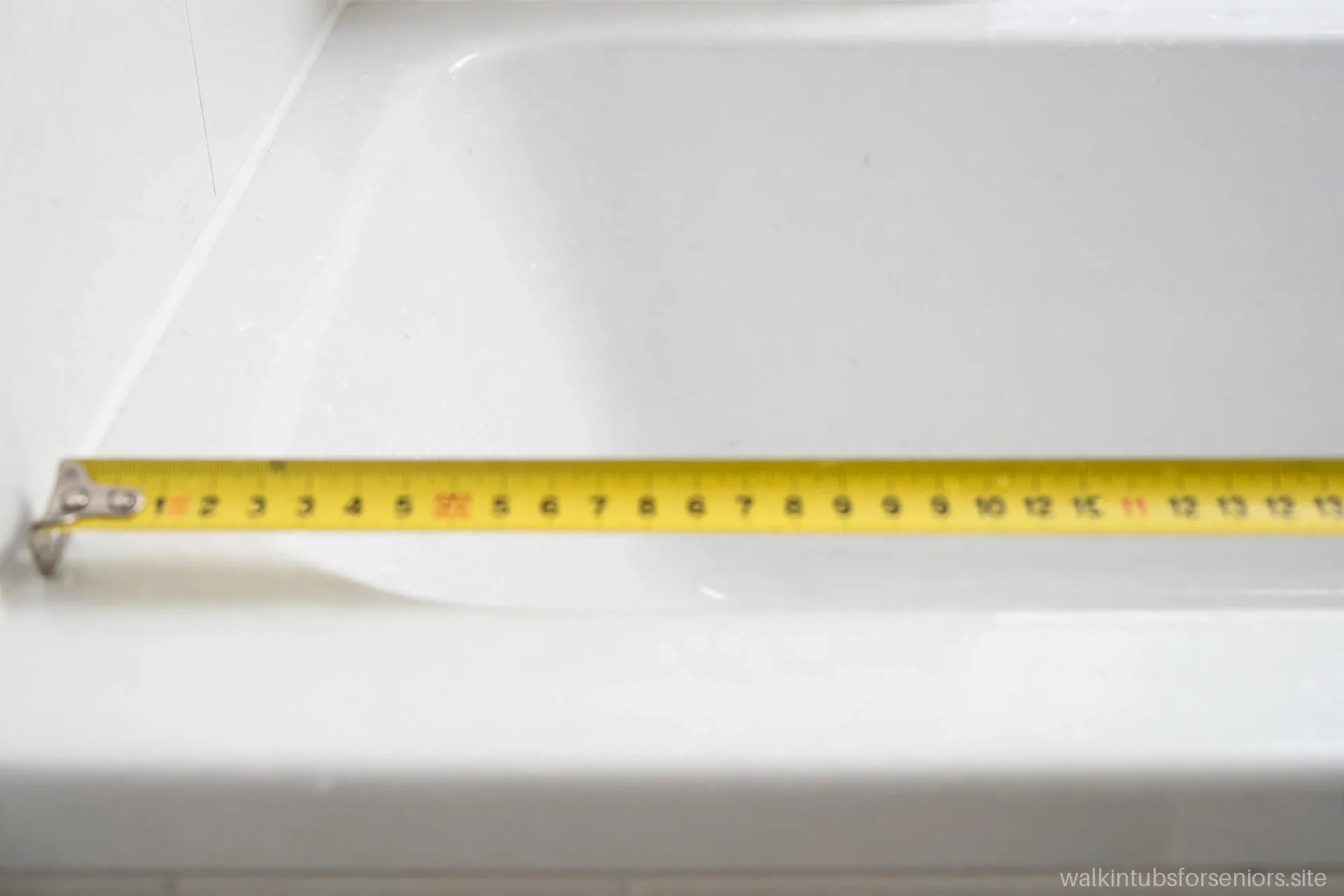Tape measure extended across the width of a walk-in tub